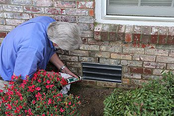 Repairing Foundation Vent Curry's employee repairing a home's foundation vent