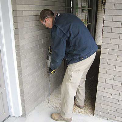 Drilling into Entryway Foundation for Termite Treatment